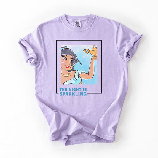 Lavender t-shirt with a graphic of a character holding a lamp and text 'The Night is Sparkling' on a white background.